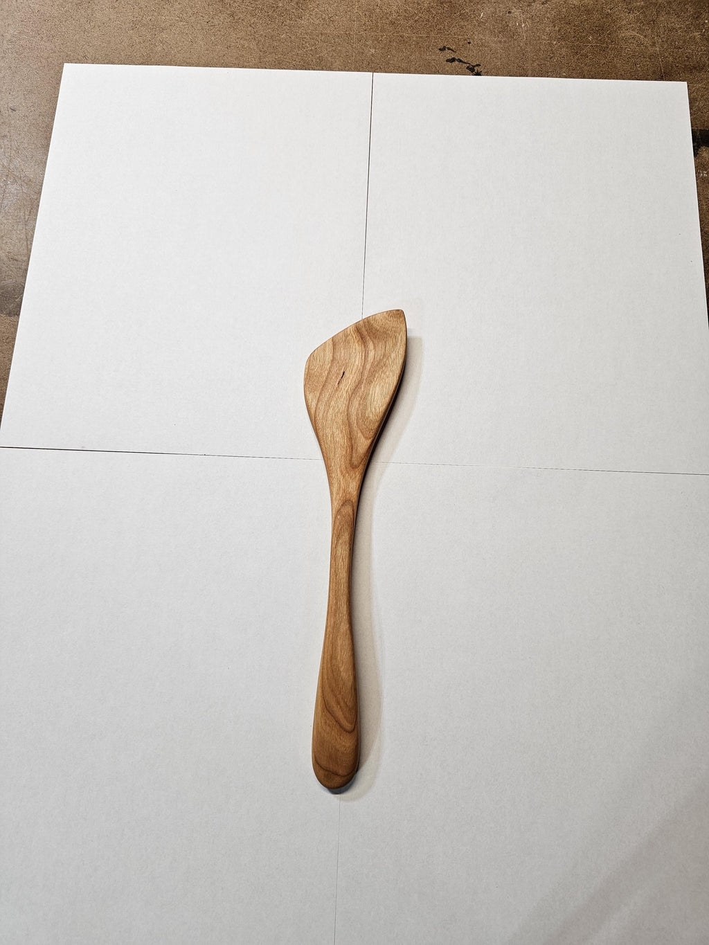angled wooden spatula on white background