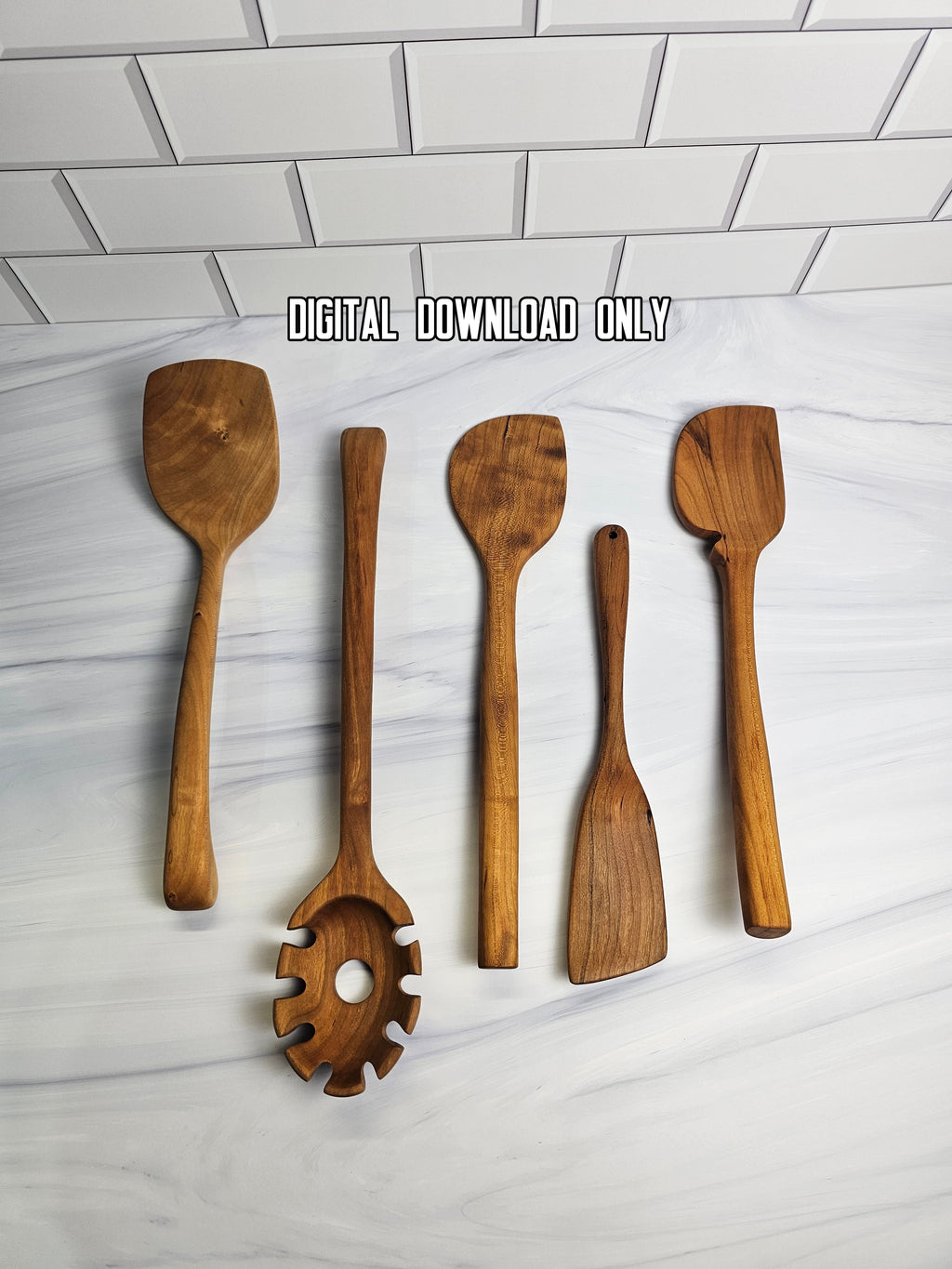 Set of wooden kitchen utensils on a white marble surface with a subway tile background.