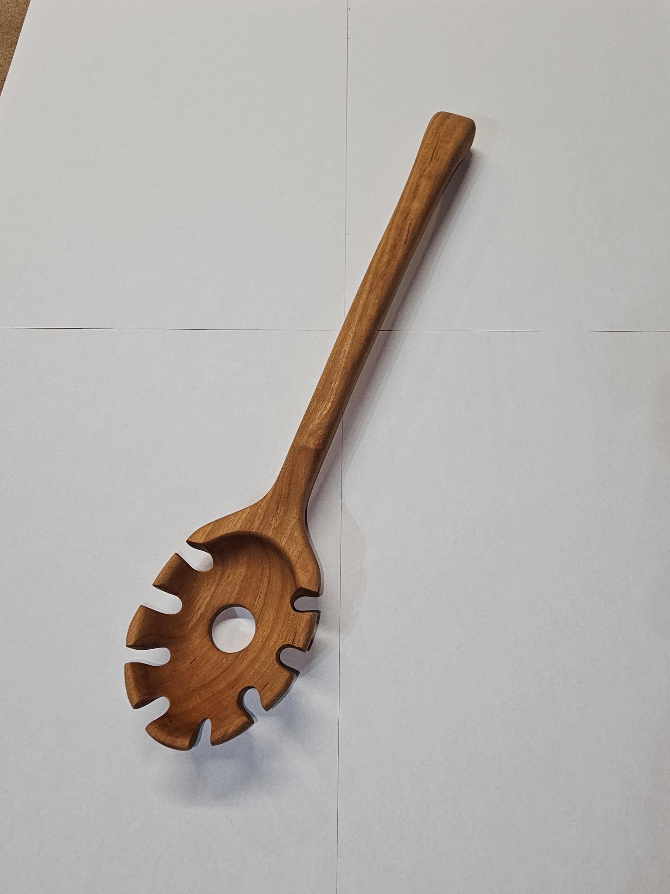 wooden spaghetti spoon on white background
